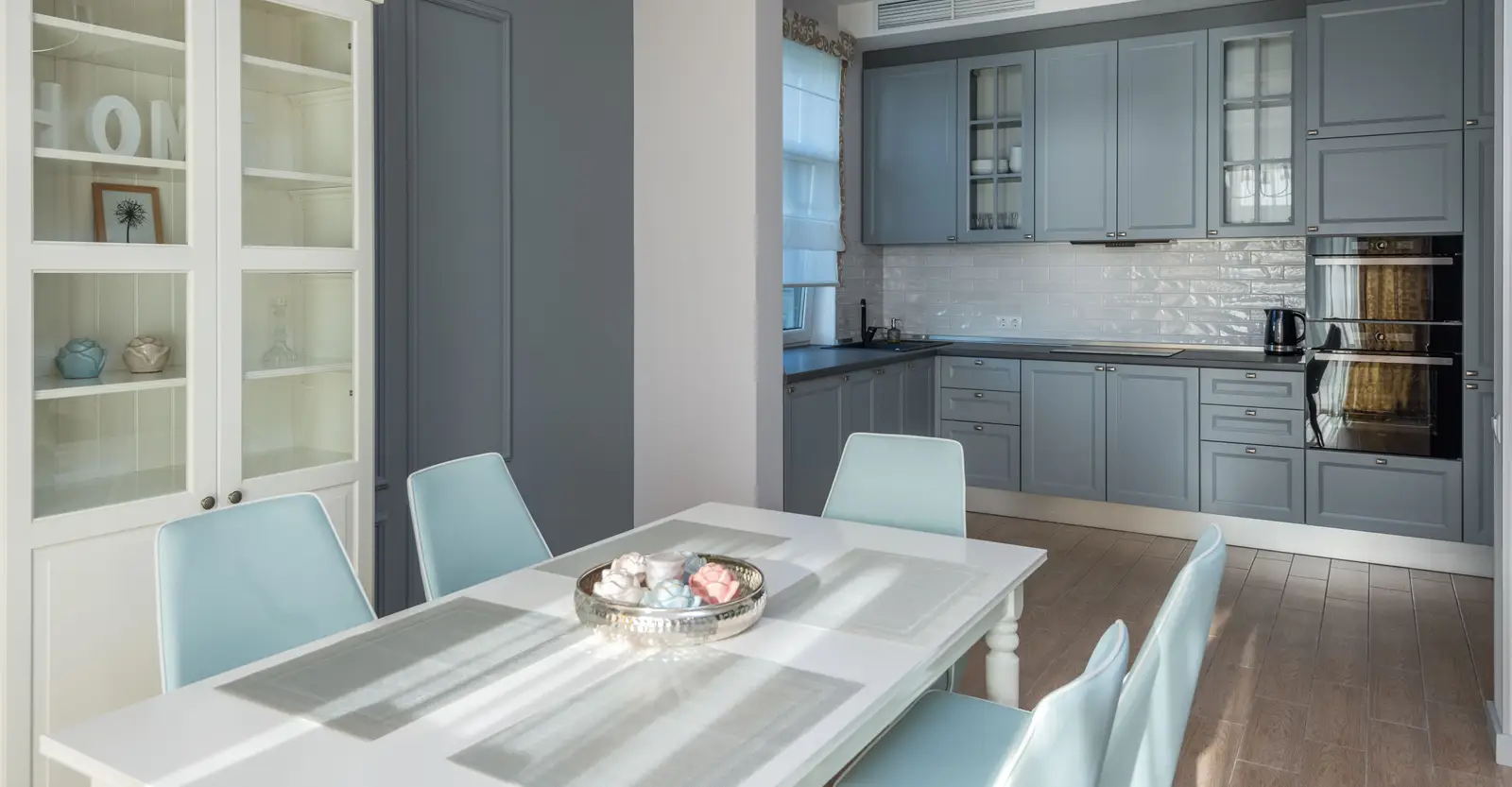 Grey painted shaker kitchen cabinets seen from the dining room